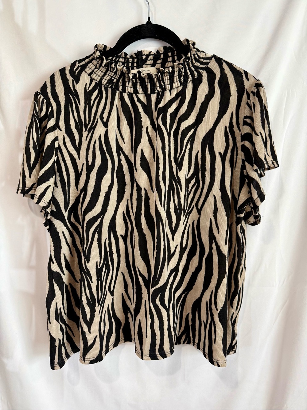 Women's Ruffle-Neck Zebra Print Top in Black and Cream
